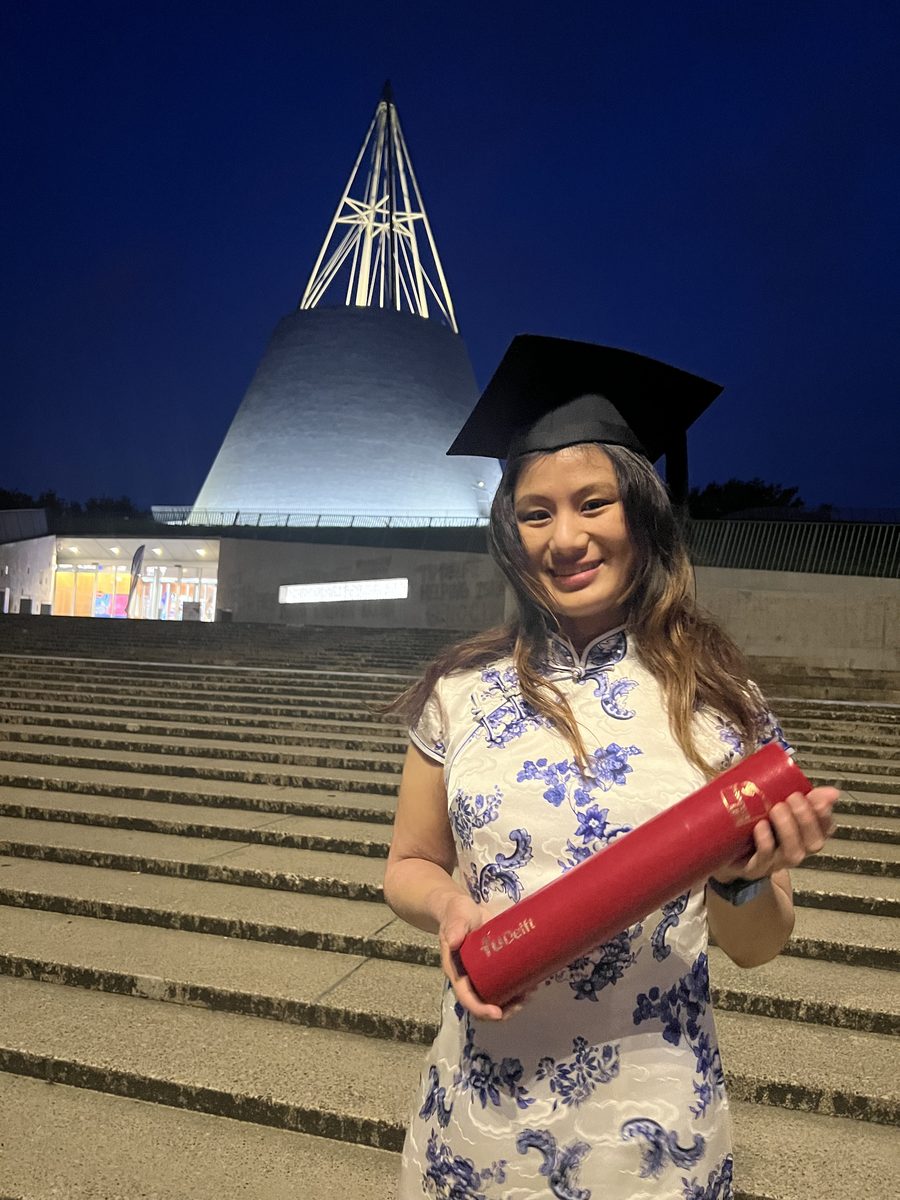 Rhea Lau at TU Delft graduation holding the diploma